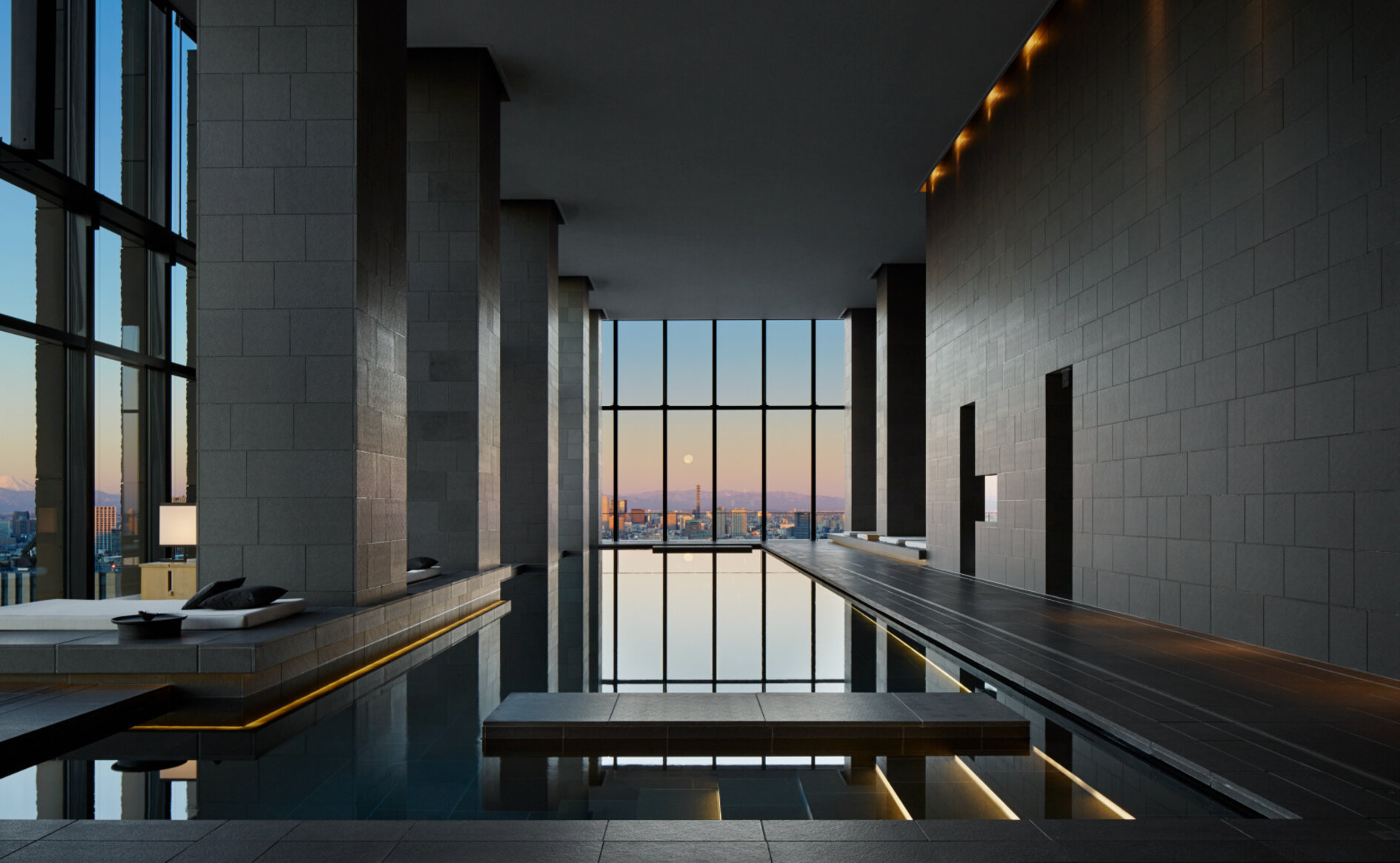 Aman Tokyo spa pool with panoramic city views at sunset — rooftop wellness retreat above Otemachi