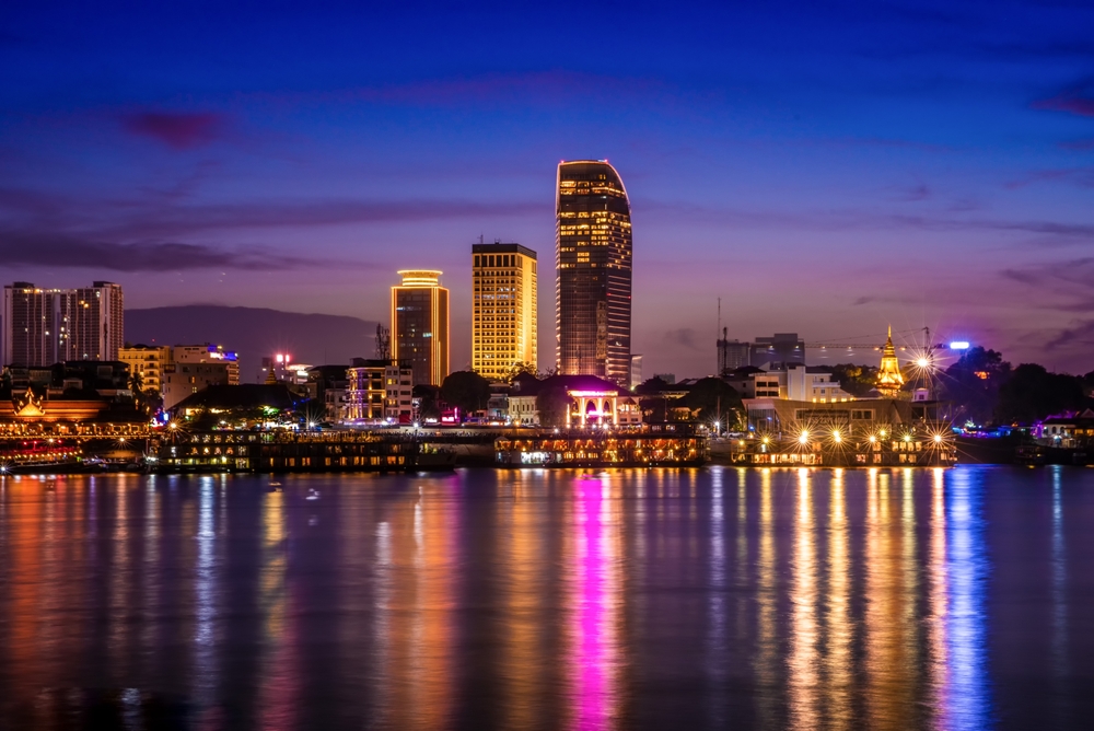 Phnom Penh skyline at twilight reflecting over the Mekong River — luxury Cambodia and Vietnam trip | HauteBlack