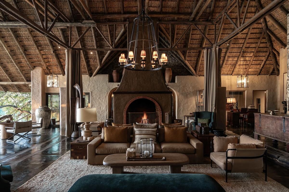 Luxury safari lodge deck overlooking African savanna at golden hour sunset — HauteBlack South African wonders