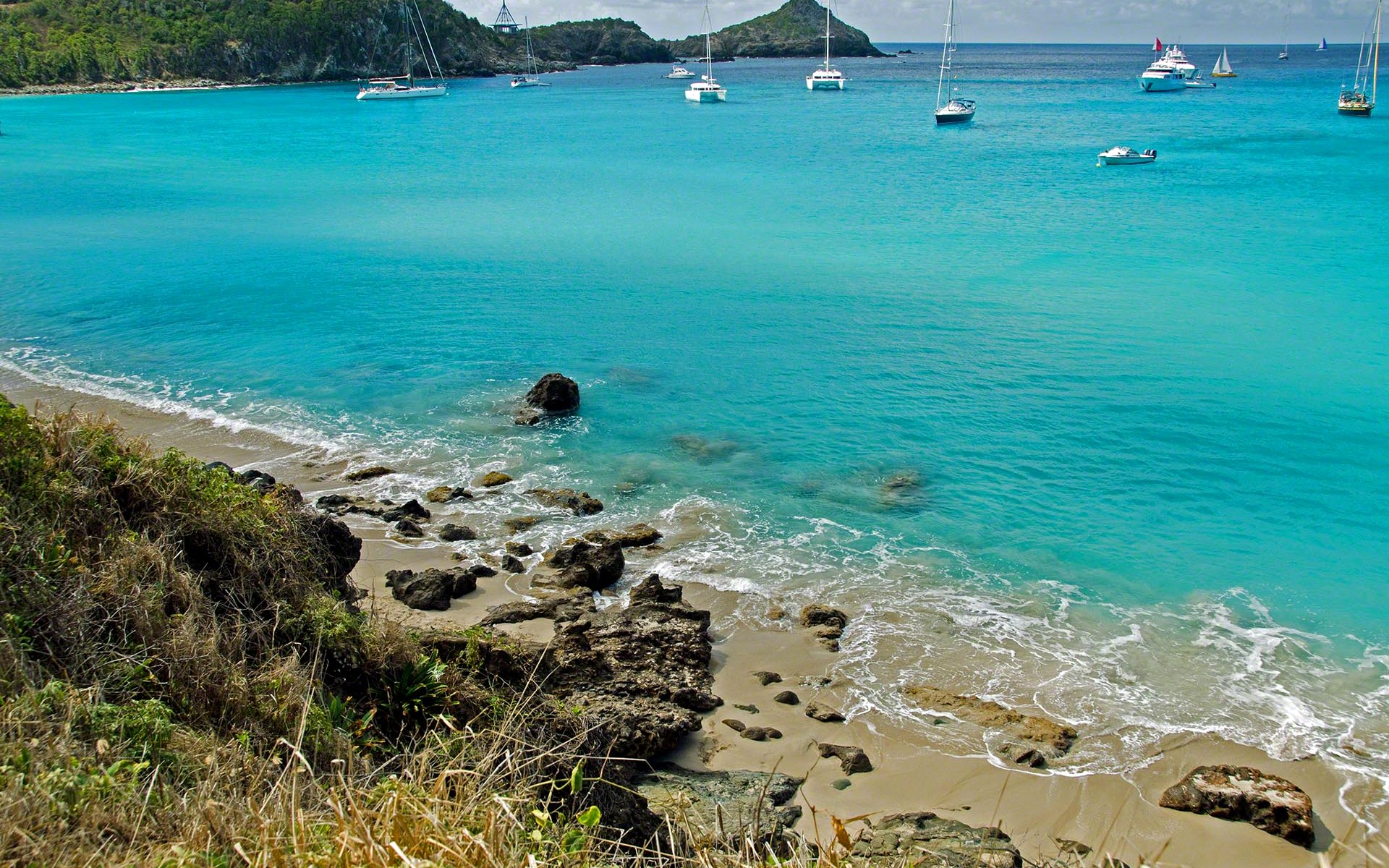Seychelles Outer Islands — a secluded white-sand cove framed by green hills — HauteBlack
