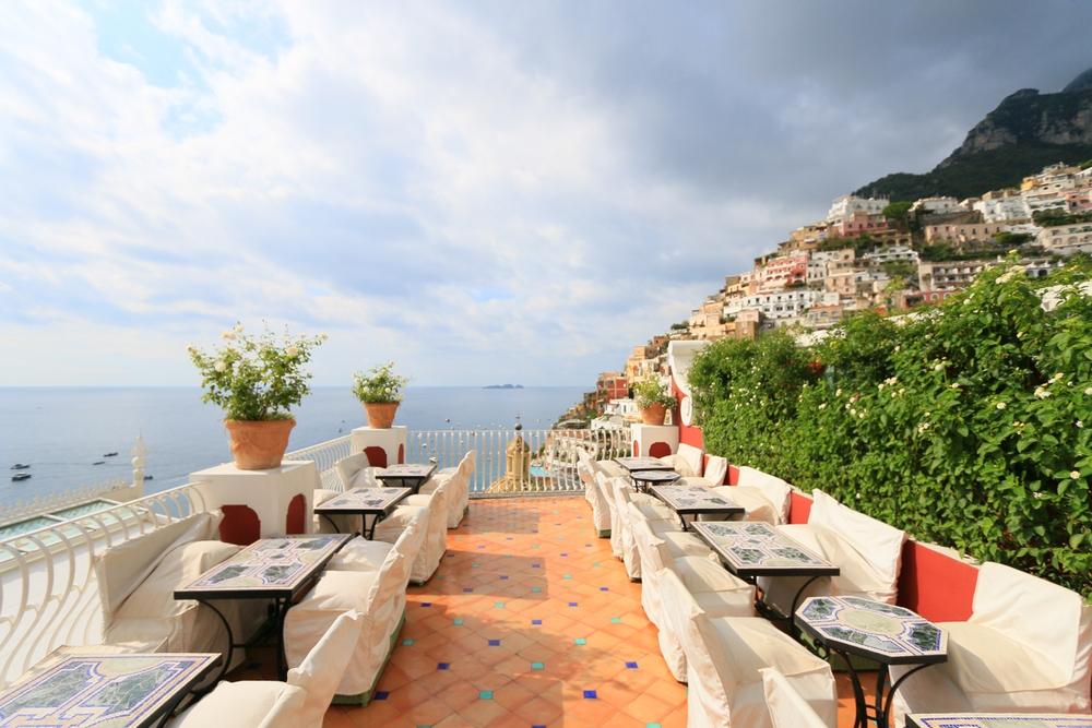 Colorful cliffside village cascading to turquoise Mediterranean water — HauteBlack Amalfi Coast & Capri